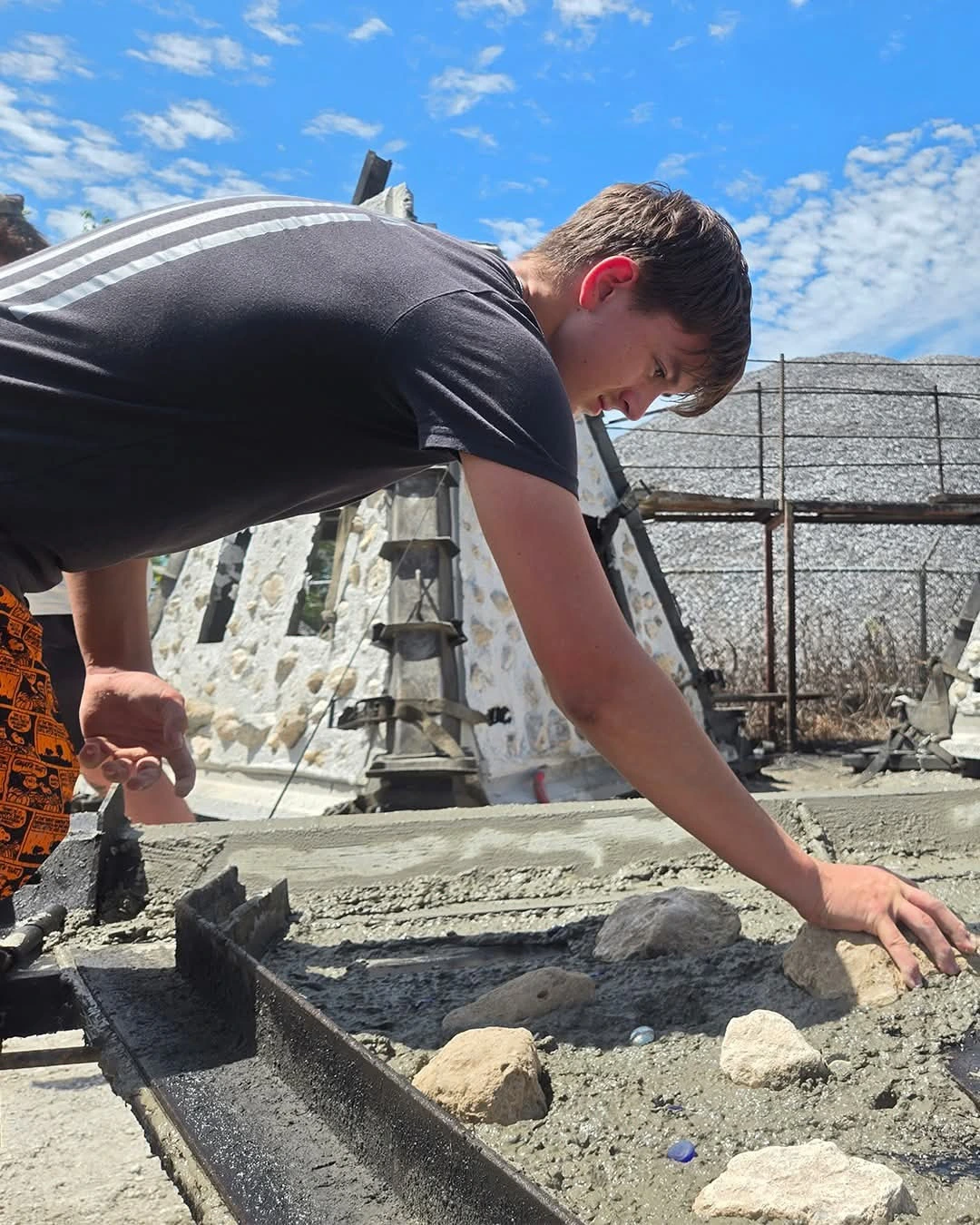 Hand-shaping marine-grade concrete while casting a memorial reef.