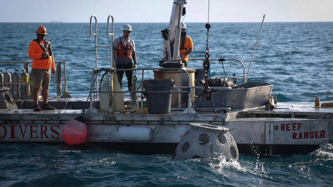 The Reef Ranger vessel and crew preparing to deploy a memorial reef offshore.
